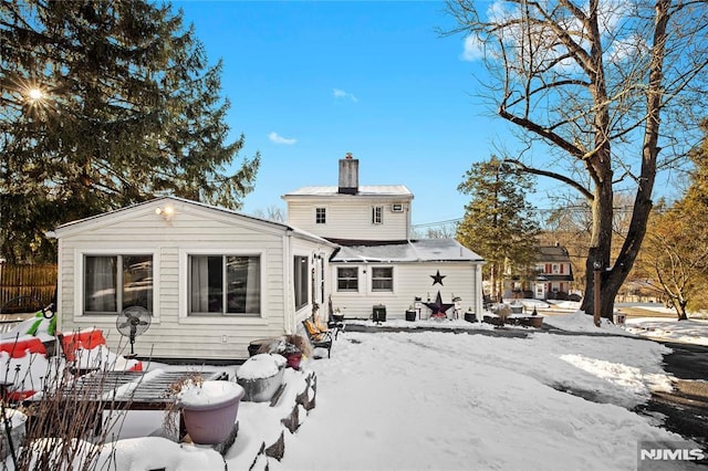 view of snow covered back of property