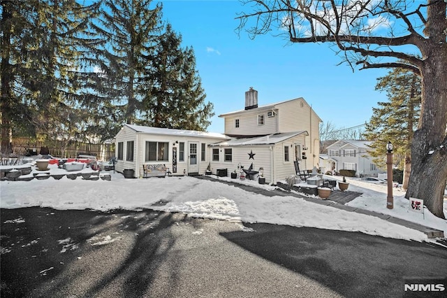 view of snow covered rear of property