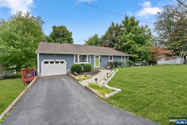 ranch-style home with a garage and a front yard