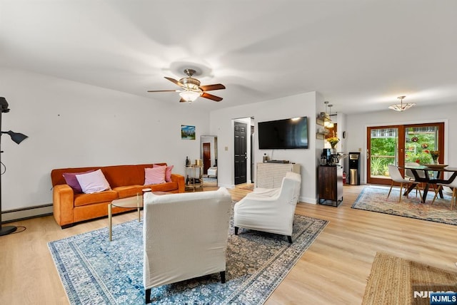 living room featuring a baseboard radiator, ceiling fan, and light wood-type flooring