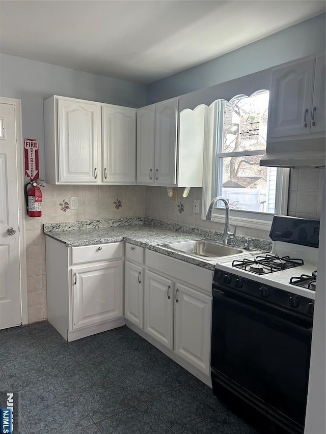 kitchen with sink, black gas range, exhaust hood, and white cabinets