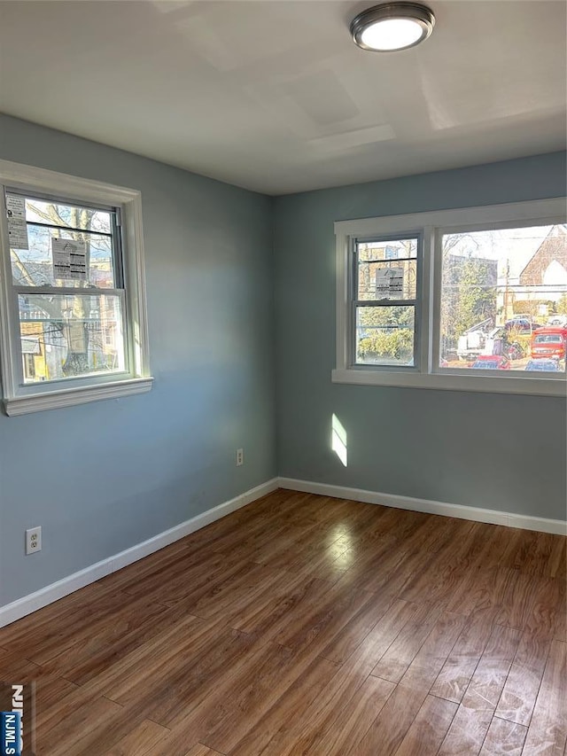 empty room with hardwood / wood-style flooring