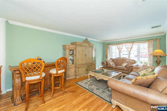 living room featuring crown molding and light hardwood / wood-style floors