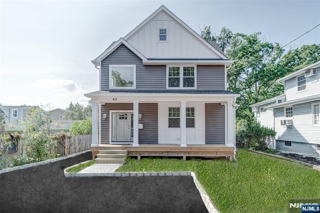 view of front of home with cooling unit, a porch, and a front lawn