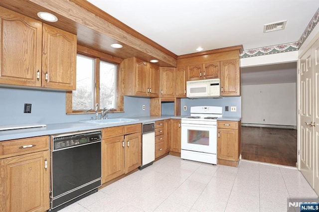 kitchen featuring sink, white appliances, and baseboard heating