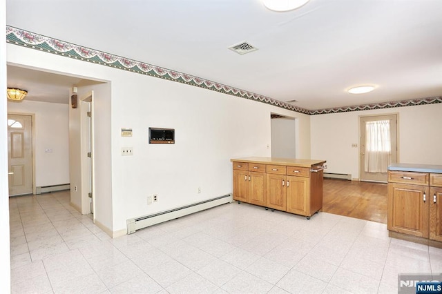 kitchen with baseboard heating and kitchen peninsula