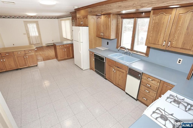 kitchen with sink, kitchen peninsula, white appliances, and baseboard heating