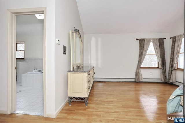 interior space featuring lofted ceiling and light hardwood / wood-style floors