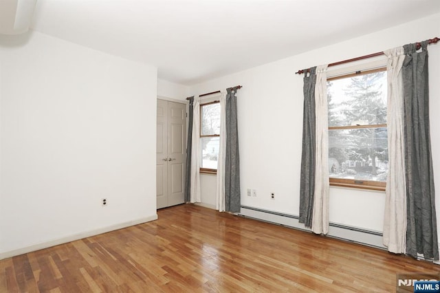 unfurnished room with a healthy amount of sunlight and light wood-type flooring