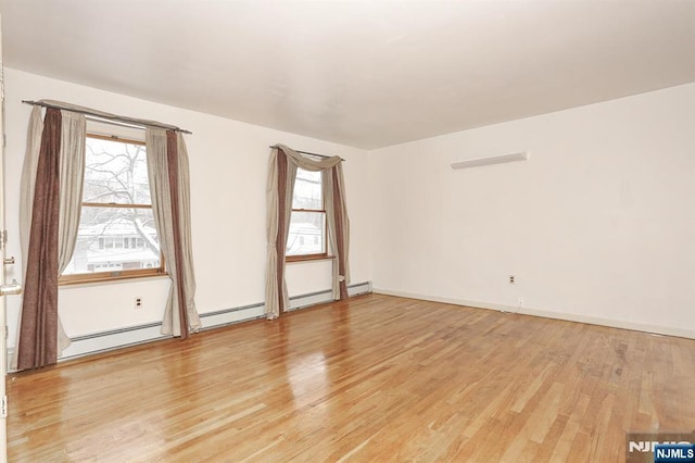 spare room with light hardwood / wood-style floors