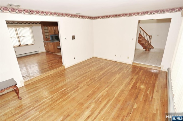 interior space featuring hardwood / wood-style floors and baseboard heating