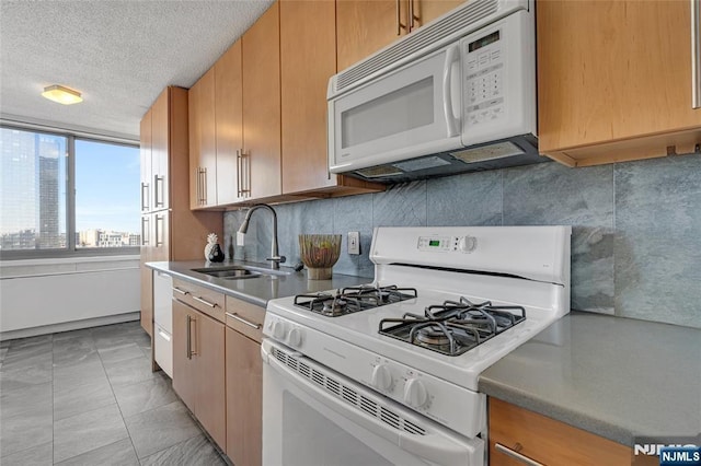 kitchen featuring white appliances, a sink, a city view, a textured ceiling, and backsplash