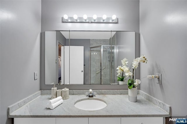 full bathroom with a stall shower and vanity