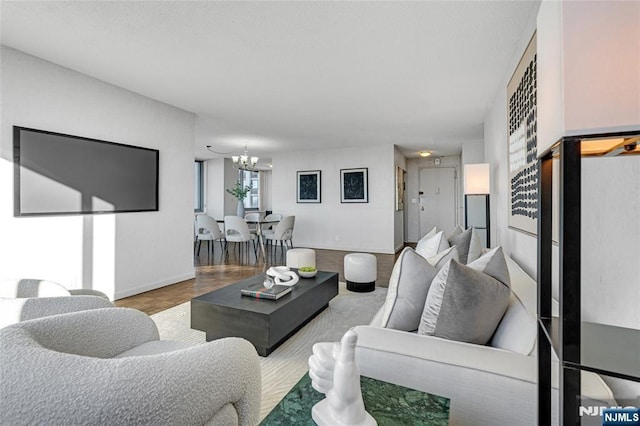 living area with a chandelier and baseboards