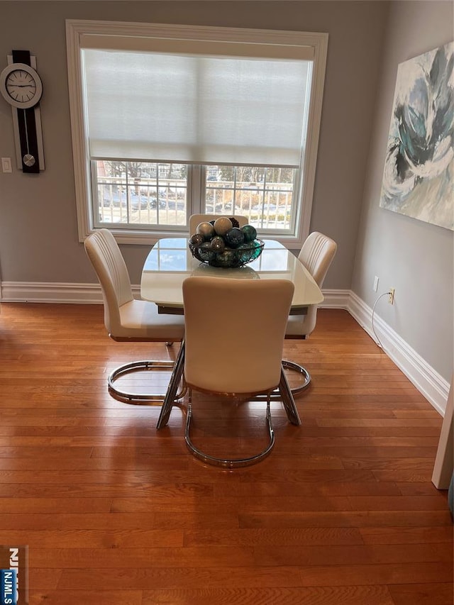 dining space with hardwood / wood-style flooring