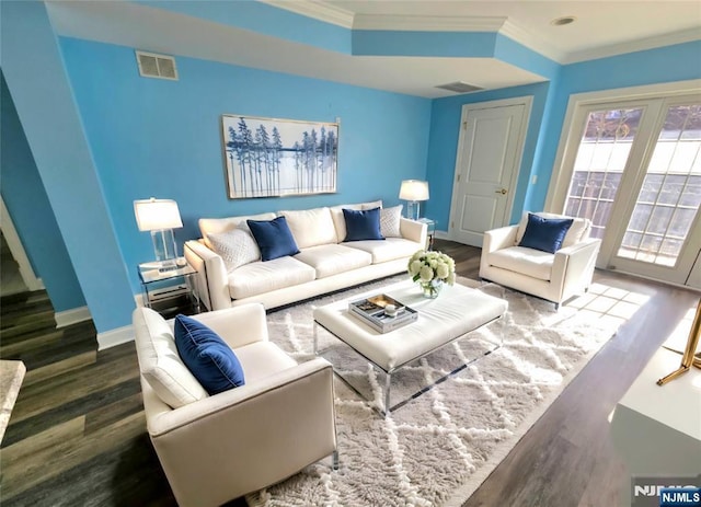 living room with hardwood / wood-style flooring and ornamental molding