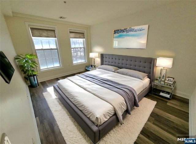 bedroom with dark hardwood / wood-style flooring