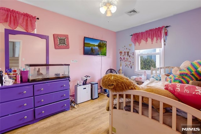 bedroom with light hardwood / wood-style floors