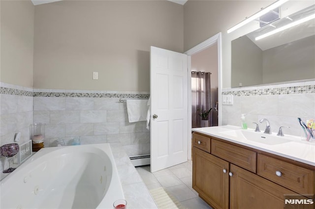 bathroom with tile walls, a bathtub, tile patterned flooring, vanity, and baseboard heating