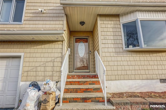 view of exterior entry with a garage