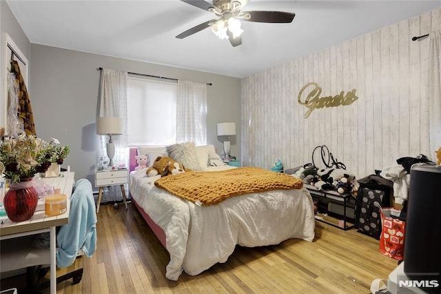 bedroom with hardwood / wood-style floors and ceiling fan