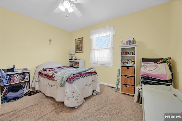 carpeted bedroom with baseboards and ceiling fan