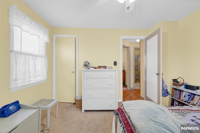 bedroom featuring light carpet