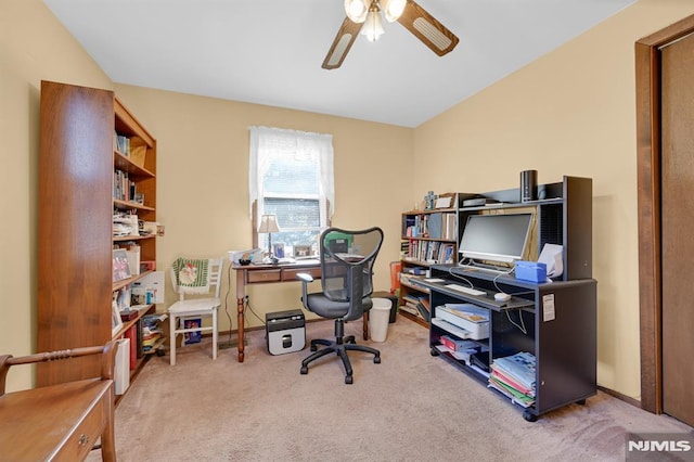 office featuring carpet floors, a ceiling fan, and vaulted ceiling