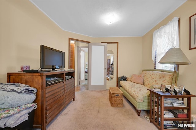 sitting room featuring light colored carpet and french doors