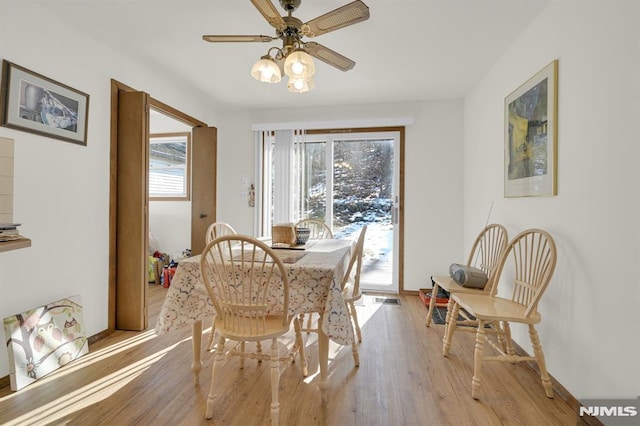 dining room featuring light wood finished floors and a ceiling fan