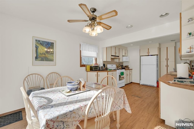 dining room featuring visible vents, light wood-style flooring, a ceiling fan, recessed lighting, and baseboards