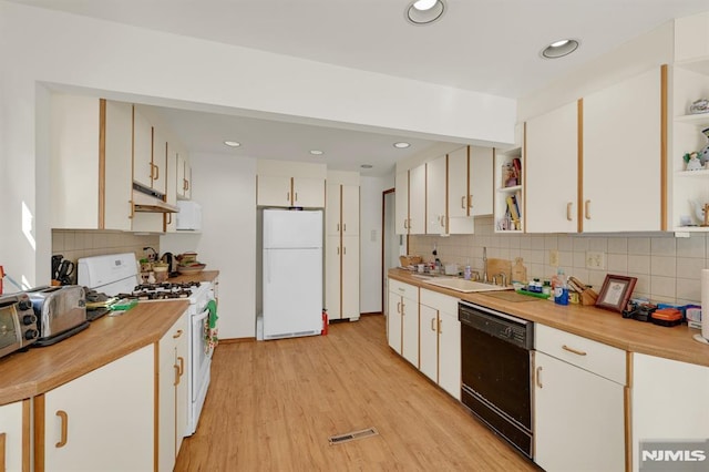 kitchen with open shelves, under cabinet range hood, light wood-type flooring, white appliances, and a sink