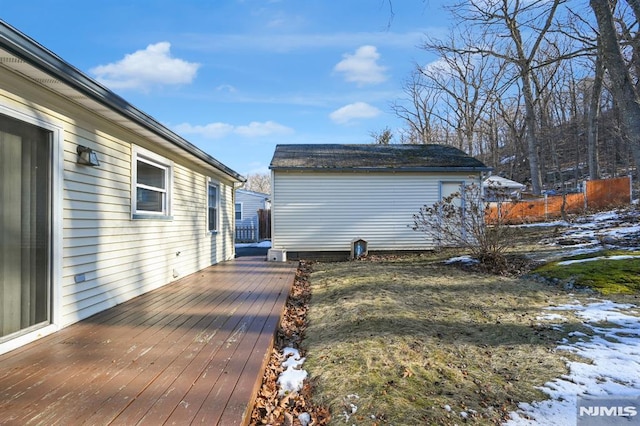 snow covered deck with an outdoor structure