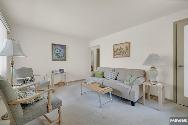 carpeted living room featuring baseboards