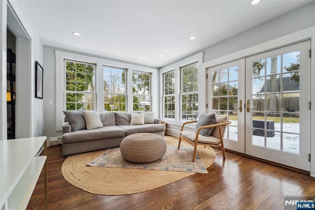 sunroom / solarium featuring french doors and a baseboard radiator