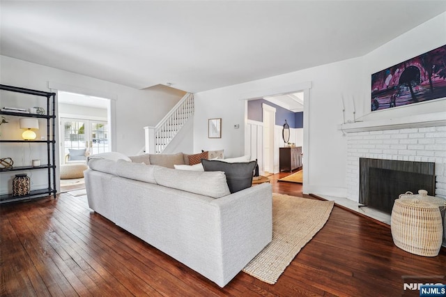 living room with dark hardwood / wood-style flooring and a fireplace