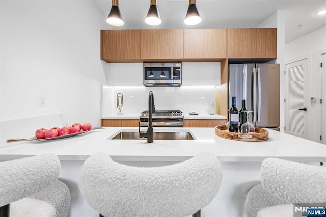 kitchen featuring stainless steel appliances and hanging light fixtures