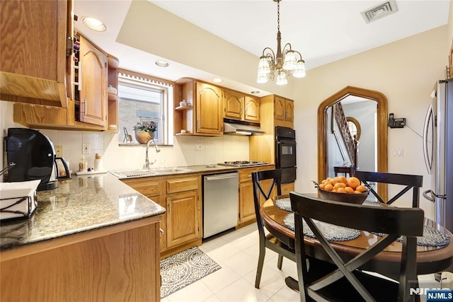 kitchen featuring sink, hanging light fixtures, backsplash, stainless steel appliances, and a chandelier