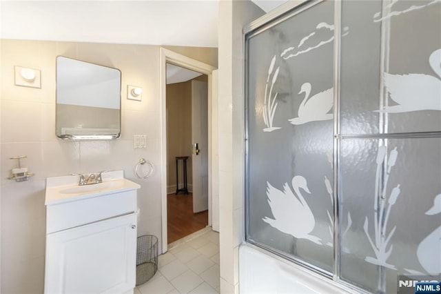 bathroom with vanity, bath / shower combo with glass door, and tile patterned flooring