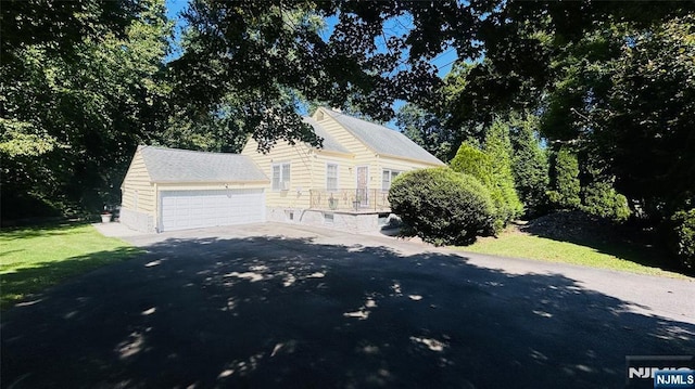 view of front of house featuring a garage and an outdoor structure