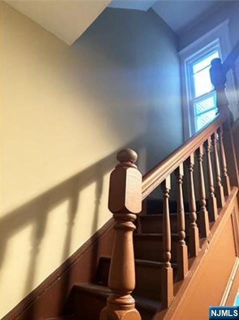 stairs with lofted ceiling