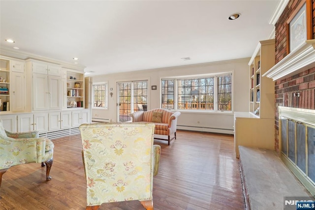 interior space with baseboard heating, a brick fireplace, and ornamental molding