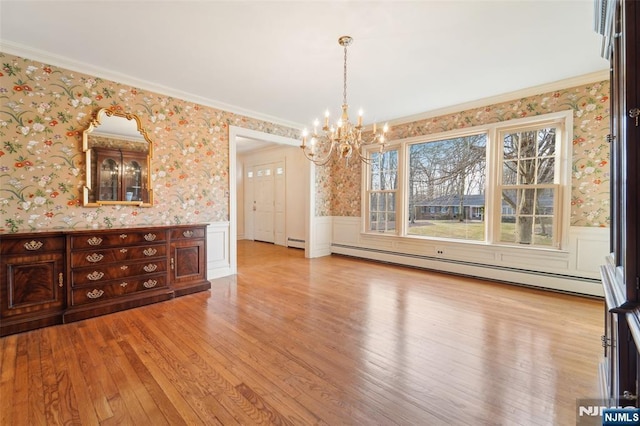 unfurnished dining area with a baseboard radiator, a notable chandelier, a wainscoted wall, and wallpapered walls