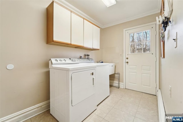 laundry area featuring crown molding, washing machine and dryer, light tile patterned flooring, and cabinet space