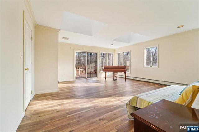 living room featuring wood finished floors, visible vents, baseboards, ornamental molding, and a baseboard heating unit