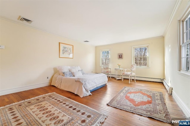 bedroom featuring visible vents, crown molding, baseboards, and hardwood / wood-style floors