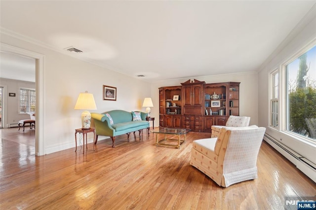 living room featuring visible vents, baseboards, a baseboard radiator, light wood-style flooring, and crown molding