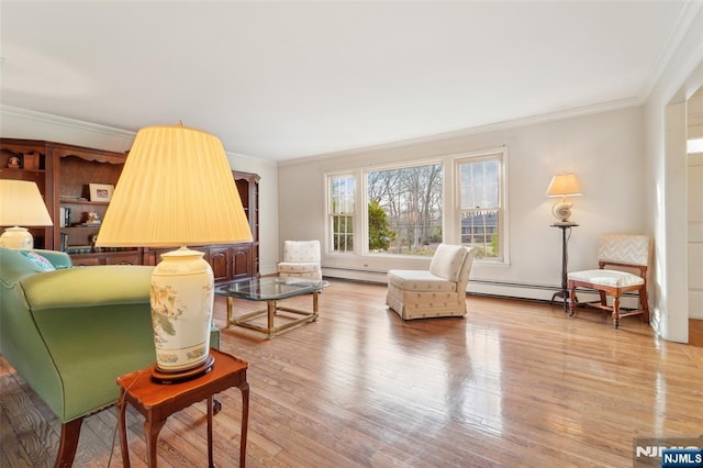 living area with a baseboard heating unit, crown molding, and light wood-style floors