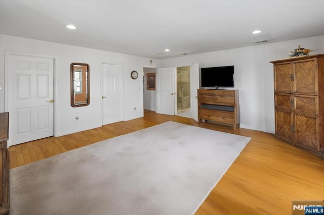 unfurnished bedroom with wood finished floors, visible vents, and recessed lighting