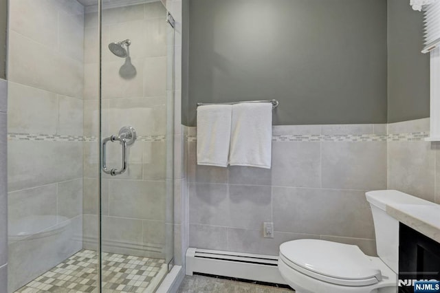 bathroom featuring tile walls, toilet, a shower stall, and baseboard heating